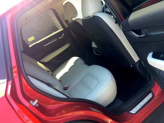 The rear cabin is roomy with adequate room for two full-size adults. The center seat is more geared towards children. The CX-5