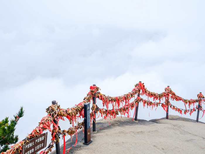 Along the top near East Peak are fences festooned with golden locks and red ribbons. It is customary for visitors to buy the locks at the mountain and lock them on the iron chains to pray for the health and safety of their friends and family.