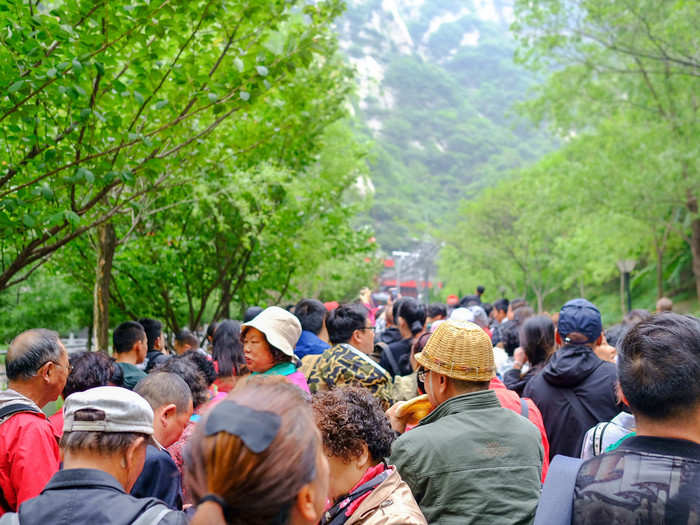 There are two cable cars to the top of Mount Hua — one to North Peak, one to West Peak. I had heard that the North Peak cable car generally has a two-hour line, while West is practically empty (because most people use it to descend). But my plan to game the system was thwarted. The West Peak cable car was closed due to wind. And that made the line for the North Peak even worse.