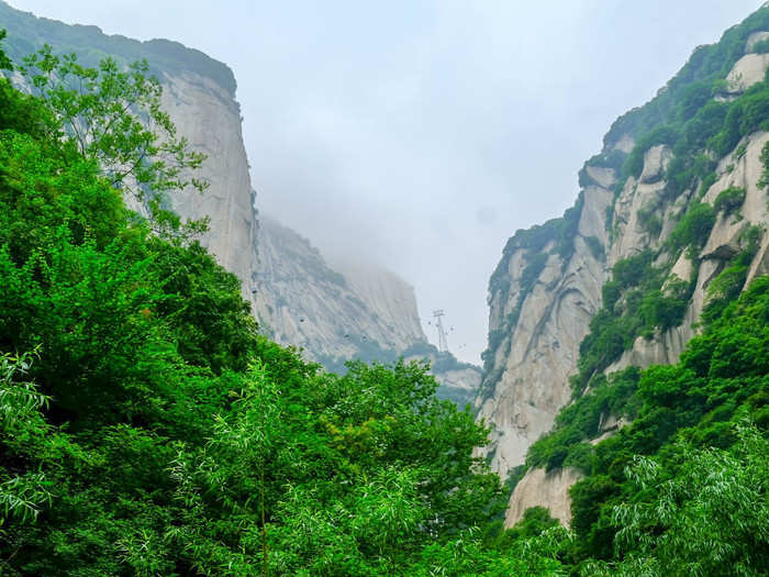 The view from the bottom of Mount Hua is lush. It looks less like a single mountain than a series of granite peaks cut into a valley laden with greenery. Knowing that hiking Mount Hua