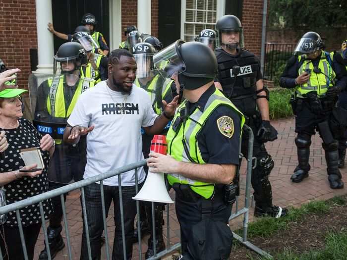 Tensions rose when Virginia State Troopers in riot gear lined up near the protestors, but Wes Bellamy, a Charlottesville city councilor, stepped in and spoke with police and protest leaders to ensure no violence erupted.