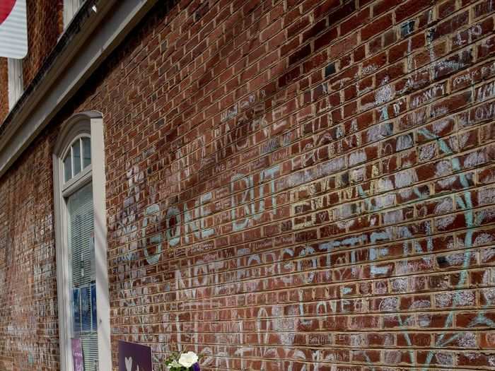 A memorial of flowers, hand-written notes, and sidewalk-chalk messages of hope, healing, and grief lay near the site where a white supremacist drove through a crowd and killed 32-year-old Heyer.