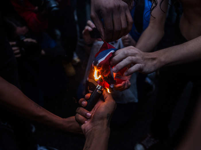 As the sun set, a group of counter-protesters burned a Confederate and alt-right flag as the Metro D.C. police looked on.