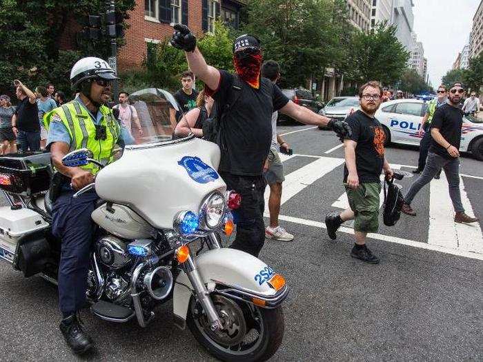 As police marched two officers deep on all sides of the 20 or so white supremacists, hundreds of counter-protesters surrounded them, drowning out all sounds but the sirens from police motorcycles.