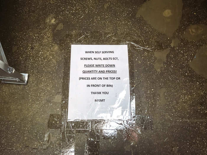 Another aisle, which carried small products like screws, nuts, and bolts, had signs taped to the floor, advising customers to write down the quantity and prices of the items they were buying. They were very easy to miss.