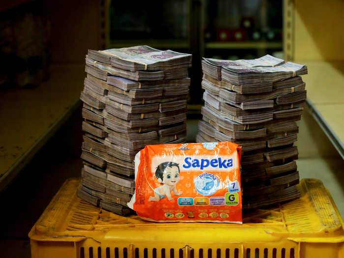 A package of diapers is pictured next to 8,000,000 bolivars, $1.22.