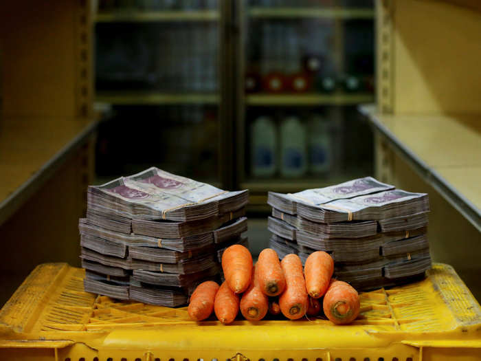 A kilogram of carrots is pictured next to 3,000,000 bolivars, or $0.46.