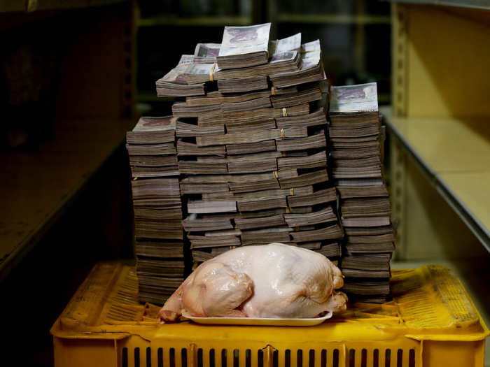 A 2.4 kg chicken is pictured next to 14,600,000 bolivars, or $2.22.