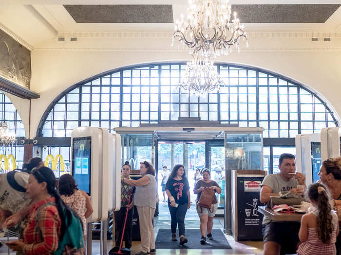 The crystal chandeliers that hang from the ceiling are a stark contrast with what one usually finds in a McDonald