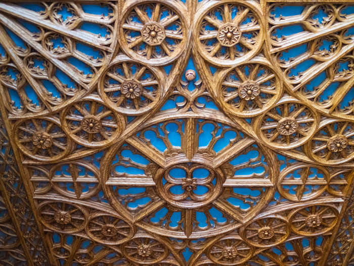 Look up and you will still be transported. The ornate ceiling is decorated with painted plaster, made to mimic sculpted wood.