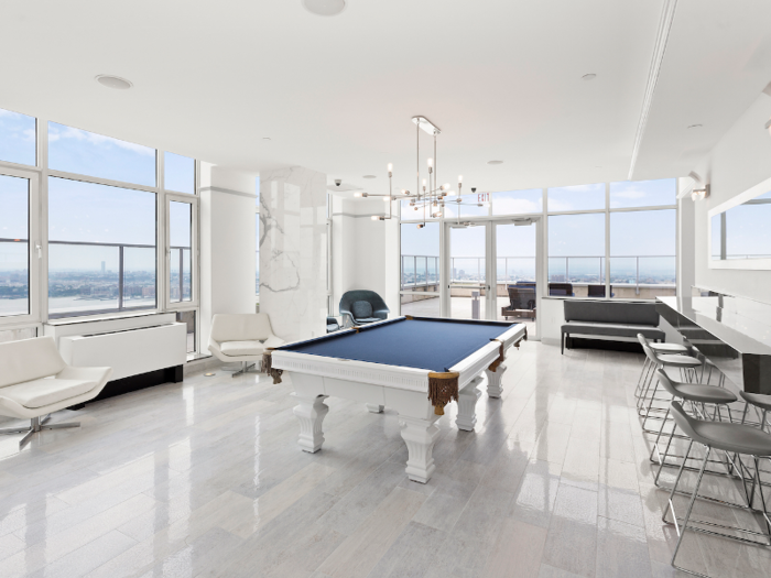 The buyer will be able to take in stunning city views while playing a game of billiards.