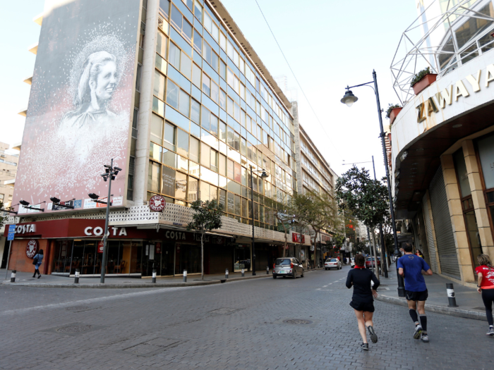 A mural dwarfs this Costa in Beirut, Lebanon.