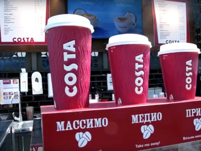 Kazakh Costas use some English text, but also a lot of Cyrillic, the alphabet in which Russian and neighbouring languages are written. This photo shows the large (massimo), medium (medio), and small (primo) sizes. The screens in the background are advertising a coconut mocha.