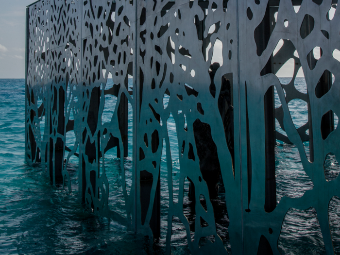 The walls were designed to mimic natural coral structures so that marine life can pass through the structure.