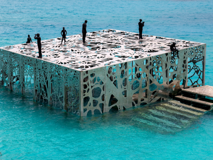 The cube-shaped building is nearly 20 feet tall, and the front facade is submerged in about 10 feet of water, depending on the tide.