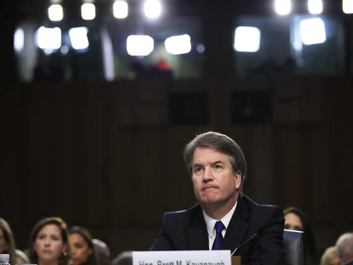 Kavanaugh sat in silence and stared straight ahead as Capitol Police dragged protesters out of the room.