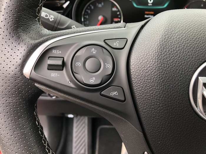 The steering wheel feels great, is leather-wrapped and perforated, and offers buttons to the left ...