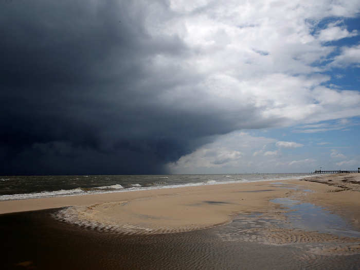 By Tuesday, the storm brought large waves, storm surges, and heavy rains to coastal counties around the Alabama-Mississippi border.