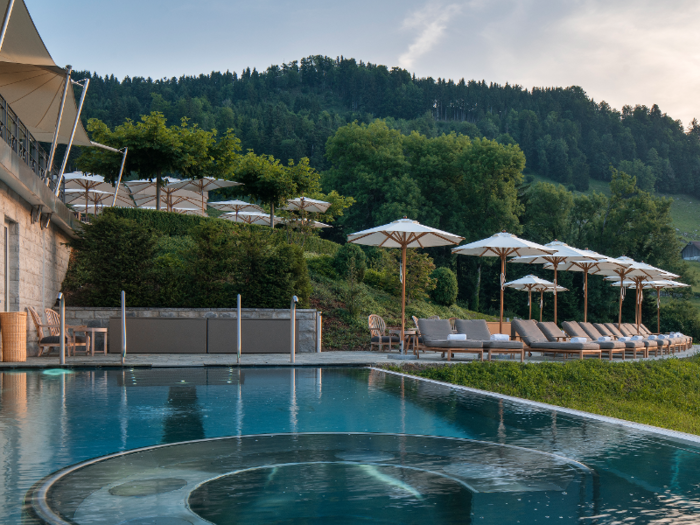 Lounge chairs near the infinity pool face the panoramic vista.