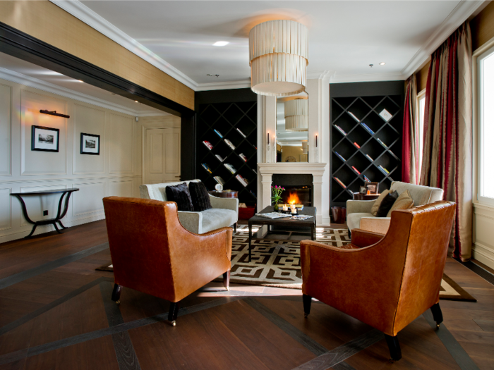 Visitors are greeted by a cozy fireplace and warm tones in the lobby.