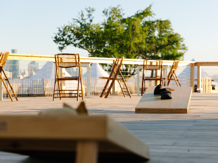 Guests can relax in a shared outdoor space with lounge chairs and games.