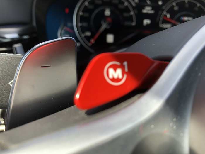 To avoid having to fiddle with the modes, you can program two red M paddles on the steering wheel. I made M1 into a no-holds-barred experience: RWD, TC off, everything set to Sport Plus.