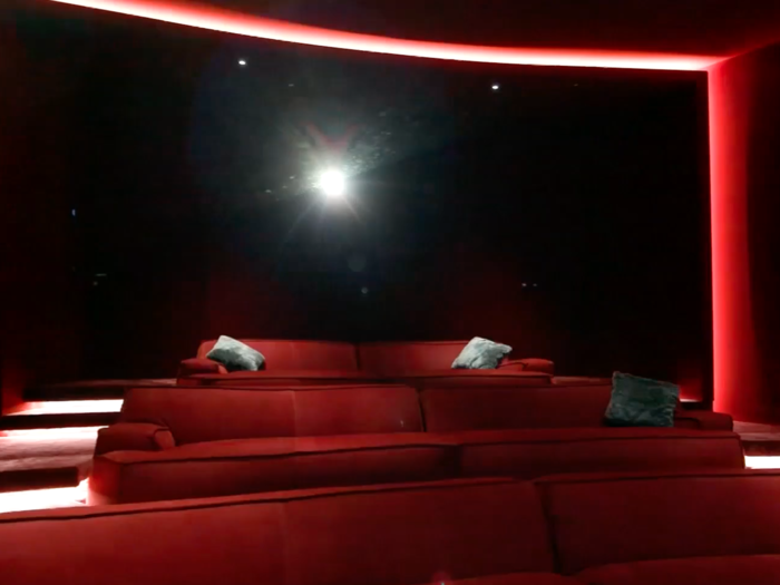 ...which is where the real extravagance begins. The underground amenities include a home theatre bedecked in red...