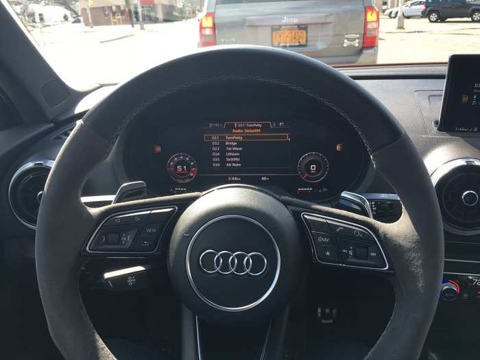 In front of the driver is an Alcantara and leather sports steering wheel. Beyond it is a 12.3-inch LCD digital instrument cluster.