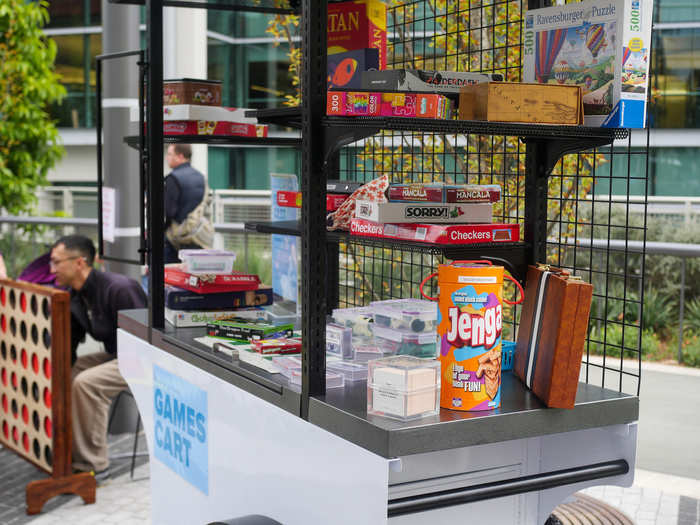 People made themselves at home on the picnic tables, playing board games provided by a games cart. A family of three hashed out a round of Connect Four behind it.