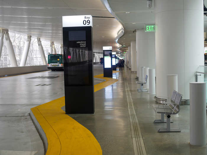 The bus deck features a succession of loading bays for different lines.