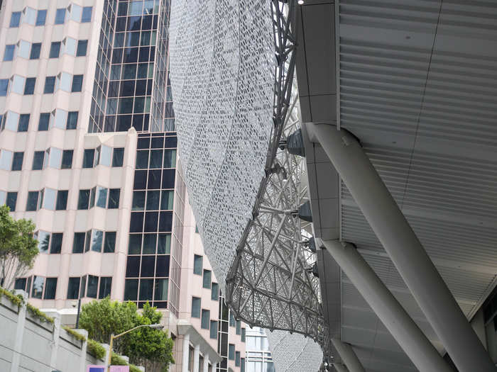 Its exterior is made from perforated white aluminum that was shaped into wave-like forms.