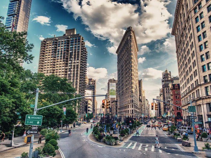 The Flatiron Building divides Broadway from 5th Avenue, and sits just below Madison Square Park at 23rd Street.