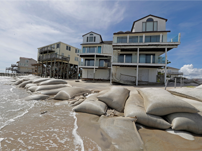 Some people living by the beach have surrounded their homes with sand bags.