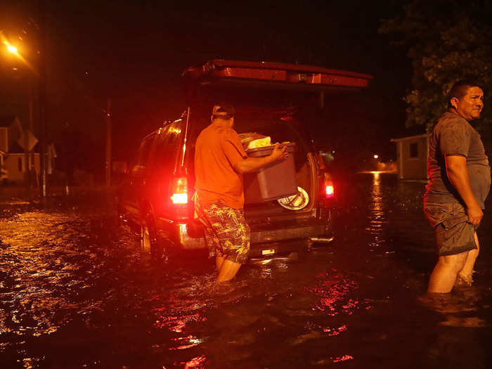 Some people are evacuating their houses. This man loads his belongings in his car as he evacuates his house in New Bern.