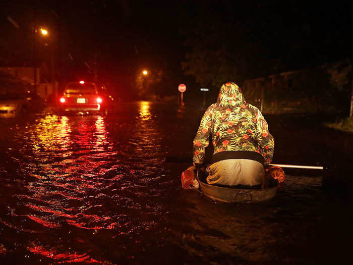 You can see his makeshift boat a little clearer here as he wades through his street late Thursday night.