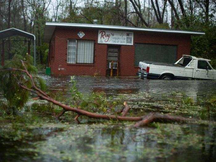 A pickup truck and garage are seen stuck in flooded waters near Wilmington, North Carolina.