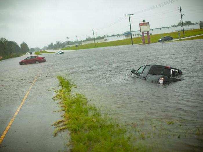 Several cars are seen stuck in flooded waters on Highway 17 between Jacksonville, North Carolina and New Bern, North Carolina.