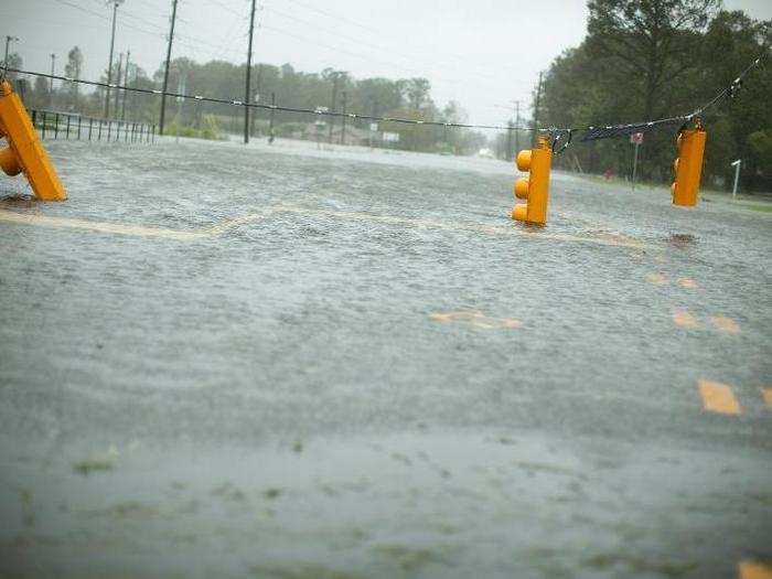 Downed street lights hang over flooded Burnett Blvd. in Wilmington, North Carolina.