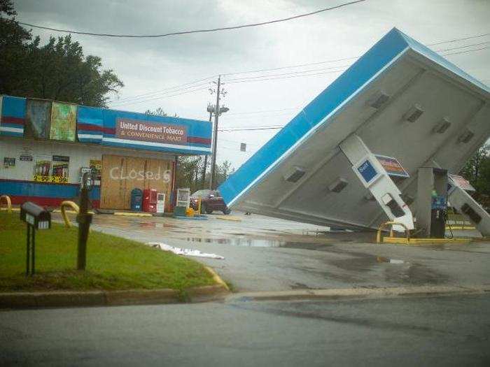 The overhang of a gas station is seen toppled over near Holly Ridge, North Carolina.