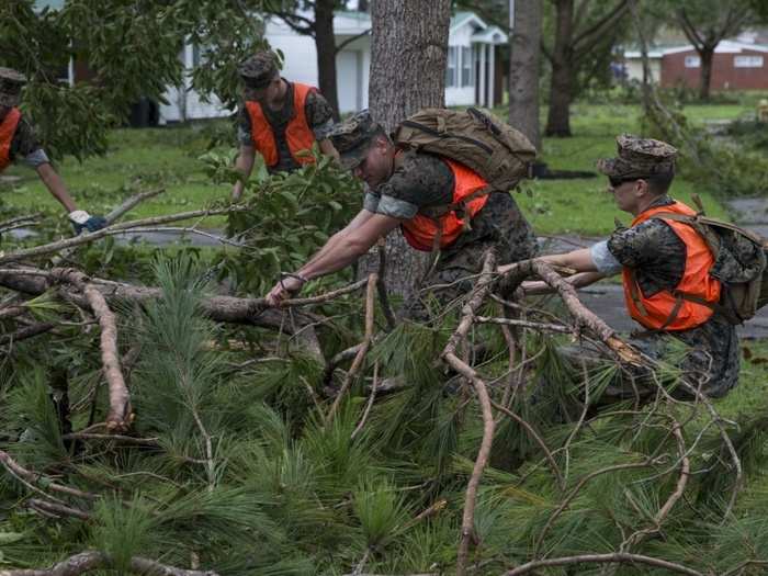 US Marines with Headquarters and Headquarters Squadron, Marine Corps Air Station New River, conduct post hurricane cleanup on MCAS New River, North Carolina, Sept. 16, 2018.