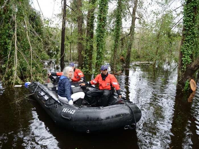 Members of Coast Guard Maritime Safety and Security Team Miami and Coast Guard Tactical Law Enforcement Team South rescue an elderly woman and her husband along with their pets after their home was flooded, Sept 16, 2018.