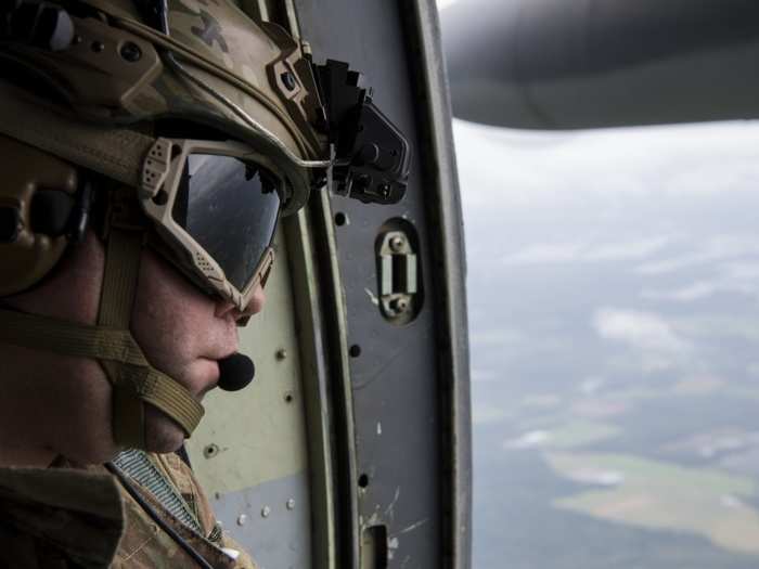 Staff Sgt. Nick Carey from the 102nd Rescue squadron, New York Air National Guard, scans for people in need of rescue over Kinston, North Carolina, Sept. 16, 2018.