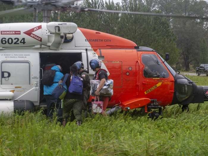 An MH-60T Jayhawk Helicopter crew from Coast Guard Air Station Elizabeth City, North Carolina, evacuates residents from Rocky Point, North Carolina.