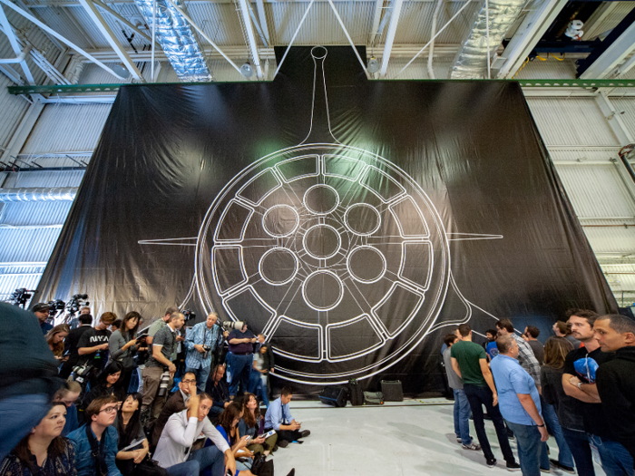 The scale of the ship is enormous. This illustration shows its bottom, and it looks enormous compared to journalists and SpaceX employees attending Maezawa