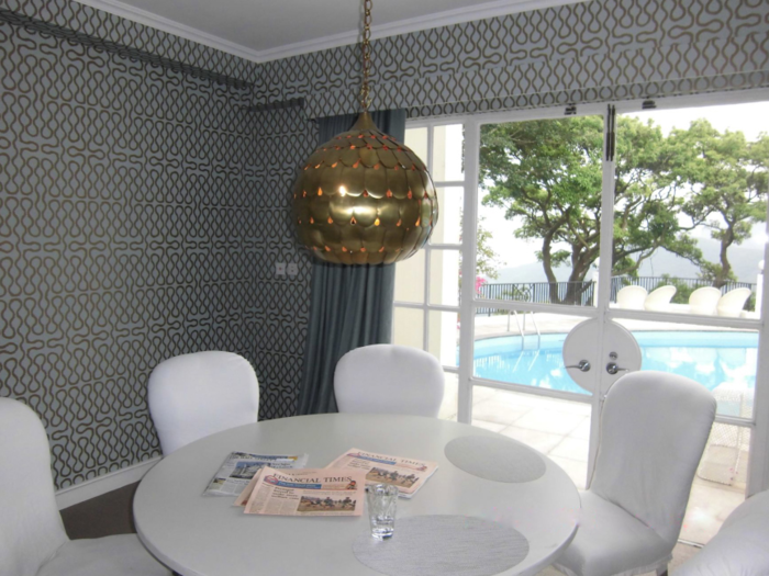 A smaller dining area overlooks the swimming pool.