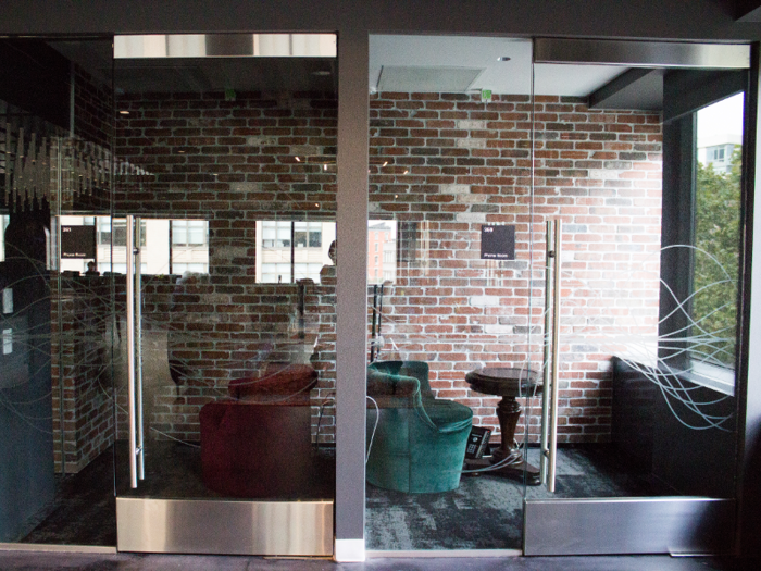 Phone rooms that also feature exposed brick are sequestered to a private corner of the space.