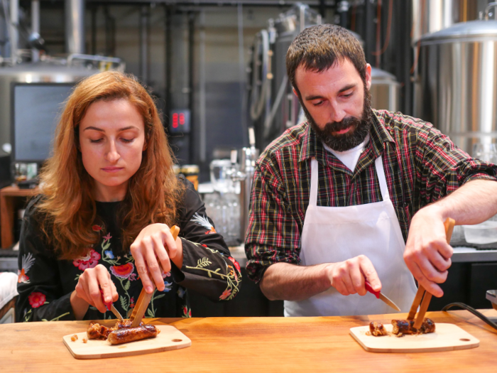 Necula and Murphy sliced the sausage into bite-sized pieces. In addition to pork fat and muscle from Jessie, the links contained spices like sage, ginger, and white pepper as well as vegetable stock and soy protein.