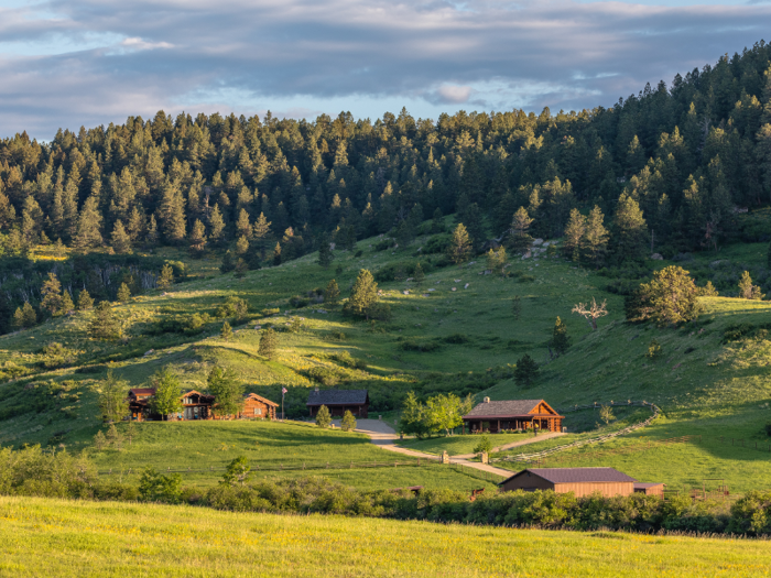 An 8,000-square-foot log home and two guest cabins sit on the property.