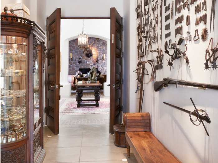 A Spanish colonial collection of ranch gear and other artifacts decorates the hallway right off the foyer.