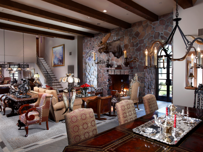 The great room includes a spacious living area and dining area with wood and stone elements.